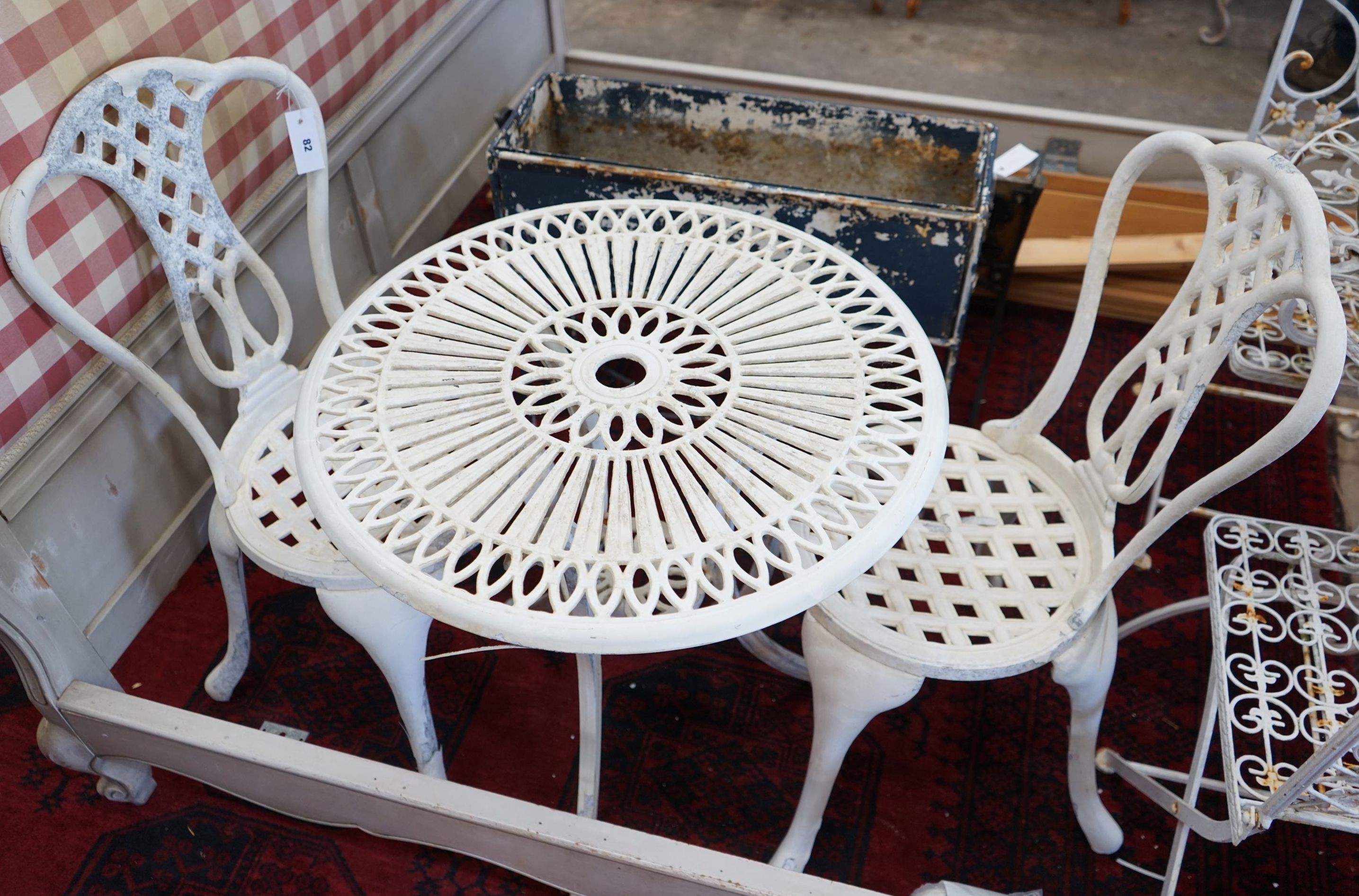A circular aluminium garden table, diameter 60cm, height 65cm and two chairs
